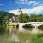 View of the old bridge and church in Bohinj, Slovenia